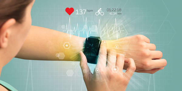 A woman tracking her heart statistics with a smartwatch.