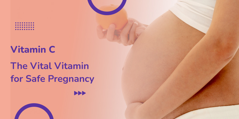 An Asian pregnant woman standing holding an orange in her hand illustrates the concept of Vitamin C for a safe pregnancy.