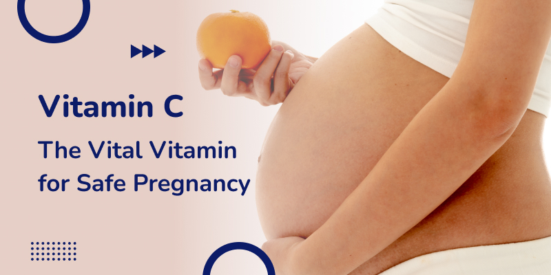 An Asian pregnant woman standing holding an orange in her hand illustrates the concept of Vitamin C for a safe pregnancy.
